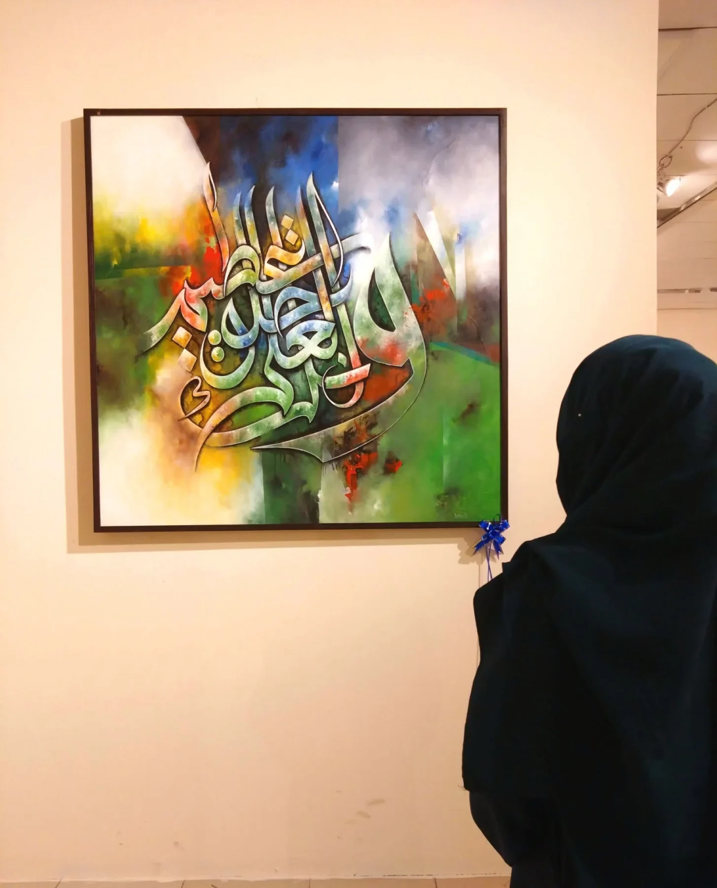 A visitor viewing a calligraphy painting