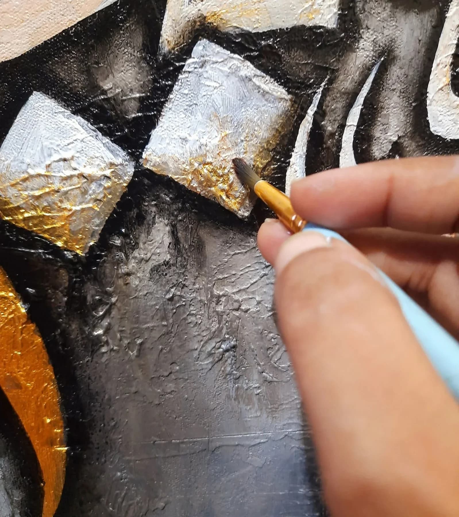 Applying gold leaf